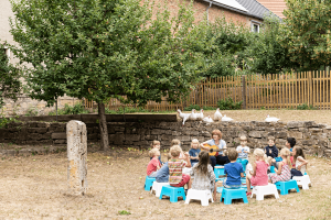 Die Schulleiterin Frau Mack-Rymatzki gibt den Schüler*innen im Garten der evangelischen Grundschule Jena Musikunterricht.